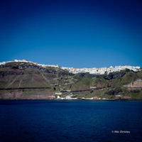 Fira city, Firostefani and Gialos port as seen from the ferry to Santorini.