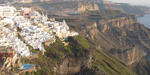Fira, The capital of Santorini island in Greece A panoramic photo of Fira, taken from Firostefani. The sun is going down.