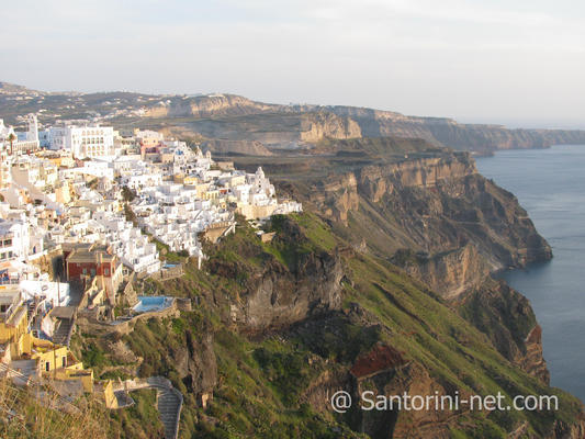 A panoramic photo of Fira, taken from Firostefani. The sun is going down.